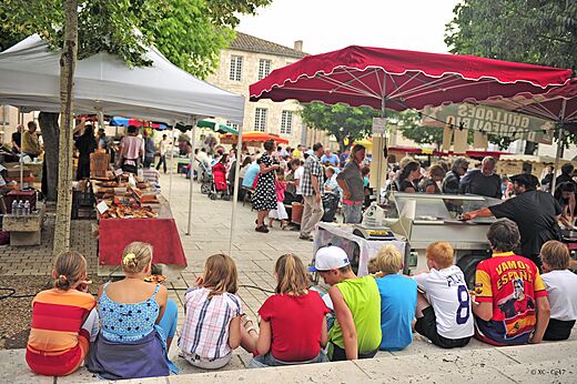 Marché animé avec stands de produits locaux et visiteurs au camping CAPFUN Ullule à Tournon d'Agenais (47).